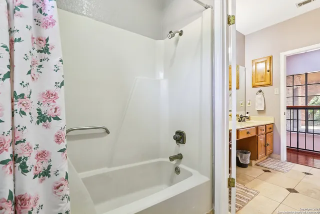 a bathroom with a bathtub and shower