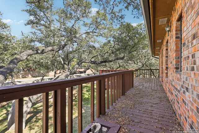 a balcony with wooden floor and fence