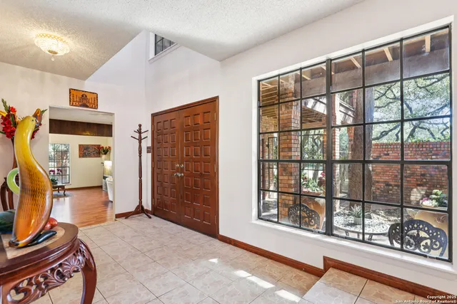a bedroom with furniture and a window