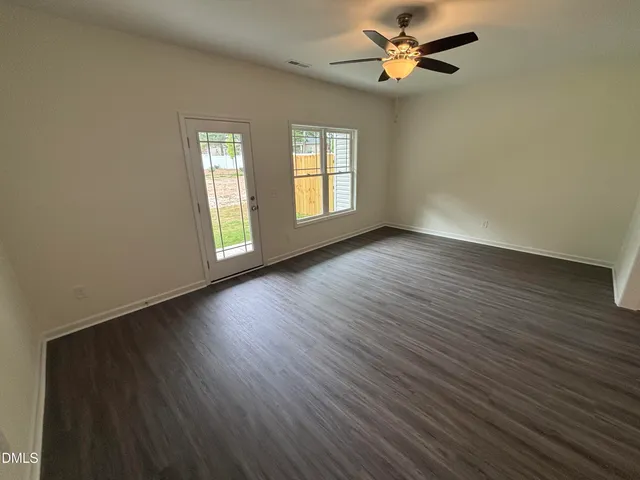 wooden floor in an empty room with a window