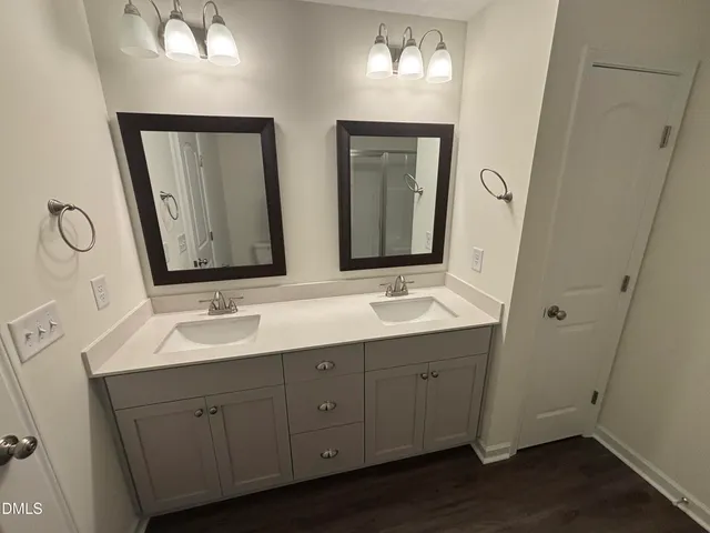 a bathroom with 2 sink and a mirror