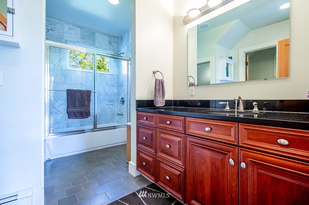 8320 Renton Avenue South Seattle, WA 98118 - Photo 18 of 39 a bathroom with a granite countertop sink a toilet and bathtub