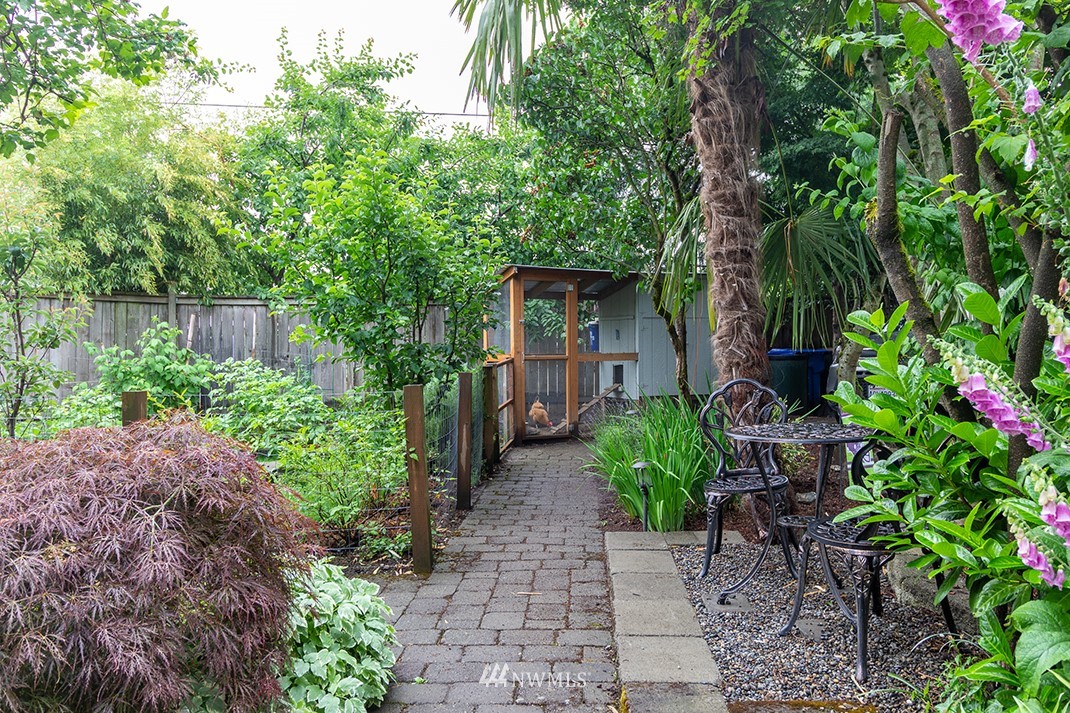 8320 Renton Avenue South Seattle, WA 98118 - Photo 25 of 39 a front view of a house with plants and a bench