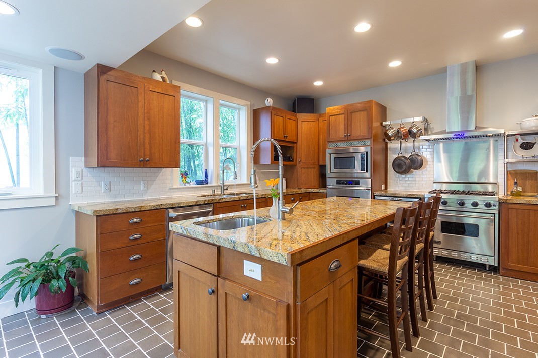 8320 Renton Avenue South Seattle, WA 98118 - Photo 10 of 39 a kitchen with stainless steel appliances granite countertop a sink a stove and a refrigerator