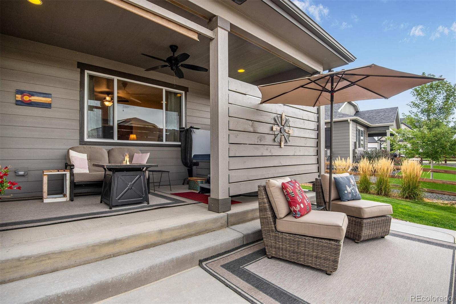 12646 Eagle River Road Firestone, CO 80504 - Photo 17 of 40 a balcony with furniture and a umbrella