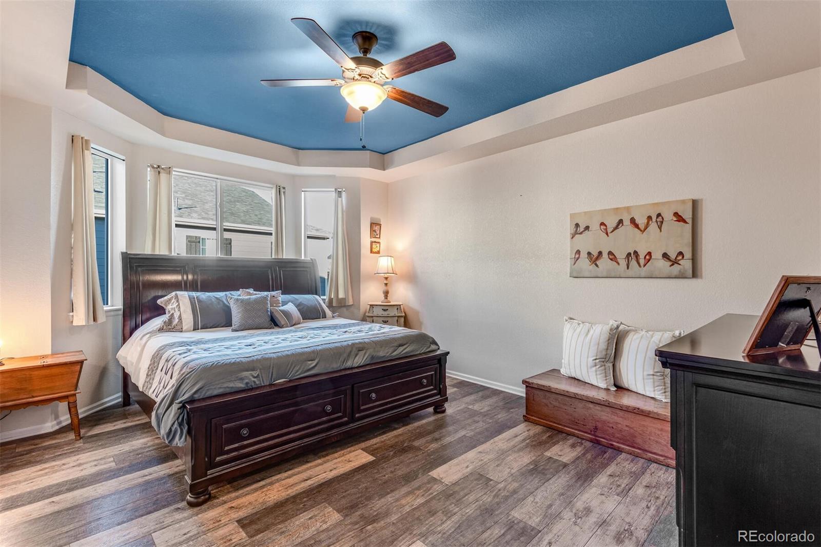 12646 Eagle River Road Firestone, CO 80504 - Photo 20 of 40 a bedroom with bed and a chandelier