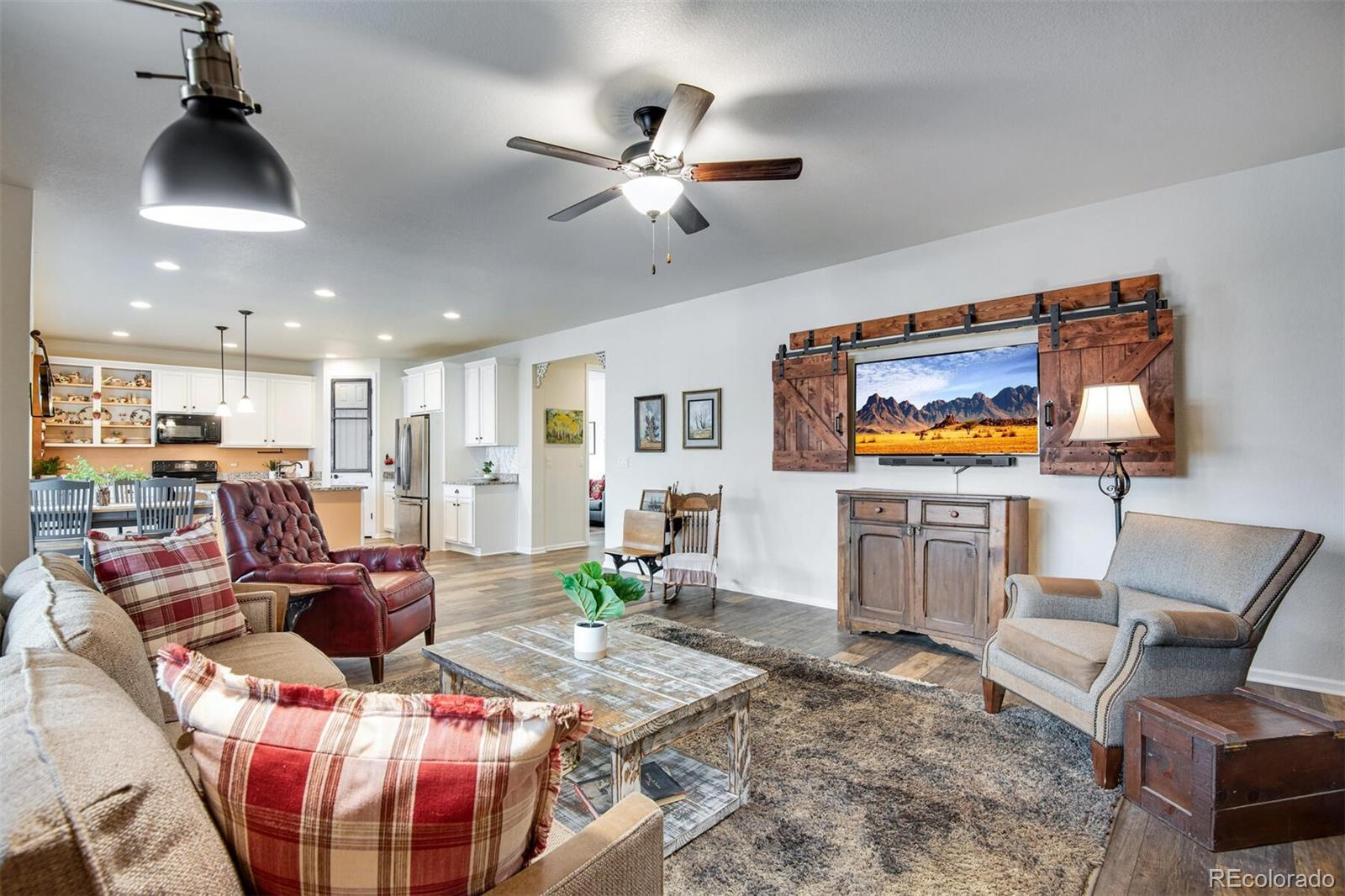 12646 Eagle River Road Firestone, CO 80504 - Photo 25 of 40 a living room with furniture and a flat screen tv