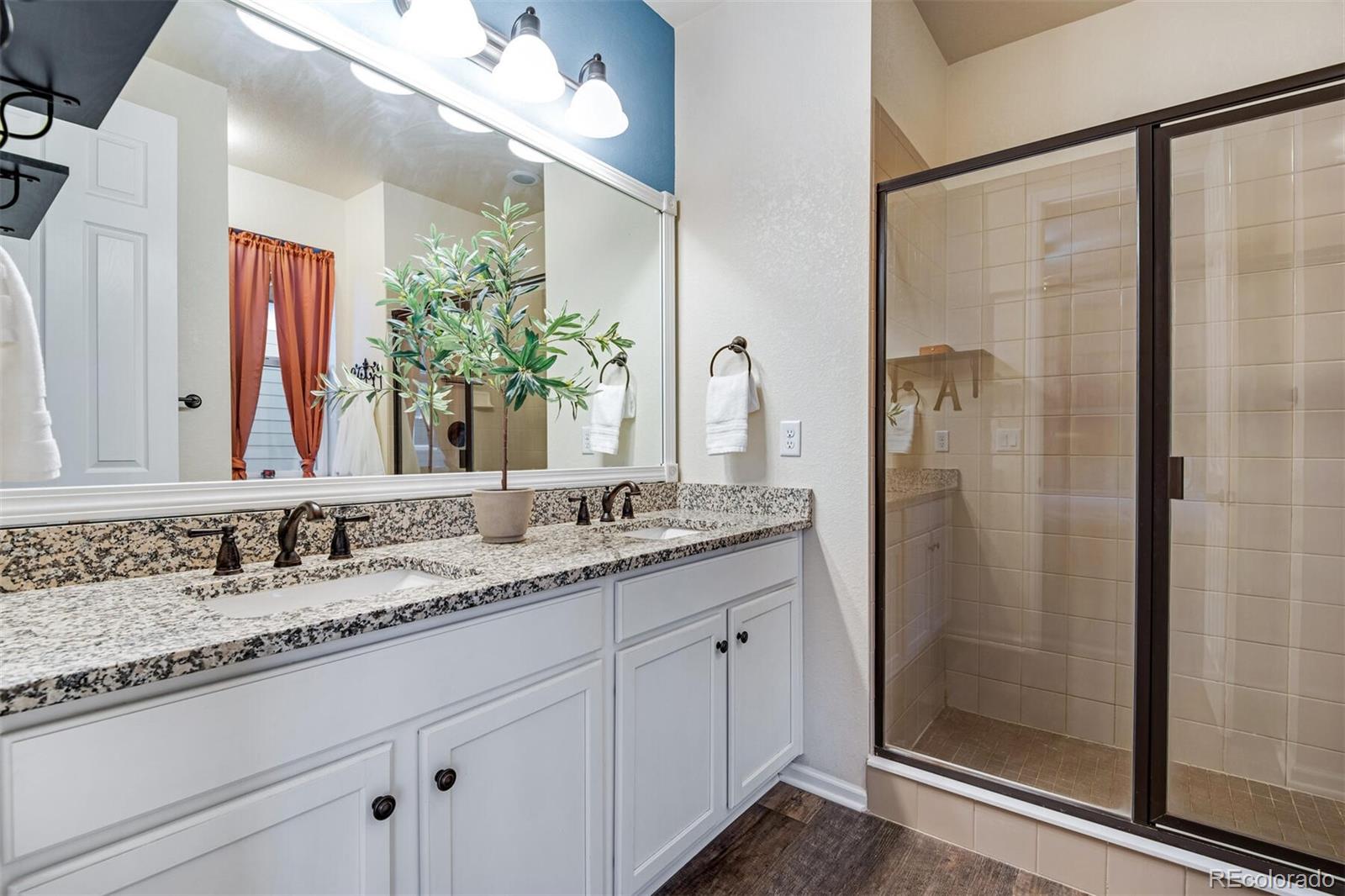 12646 Eagle River Road Firestone, CO 80504 - Photo 28 of 40 a bathroom with a granite countertop sink and a mirror