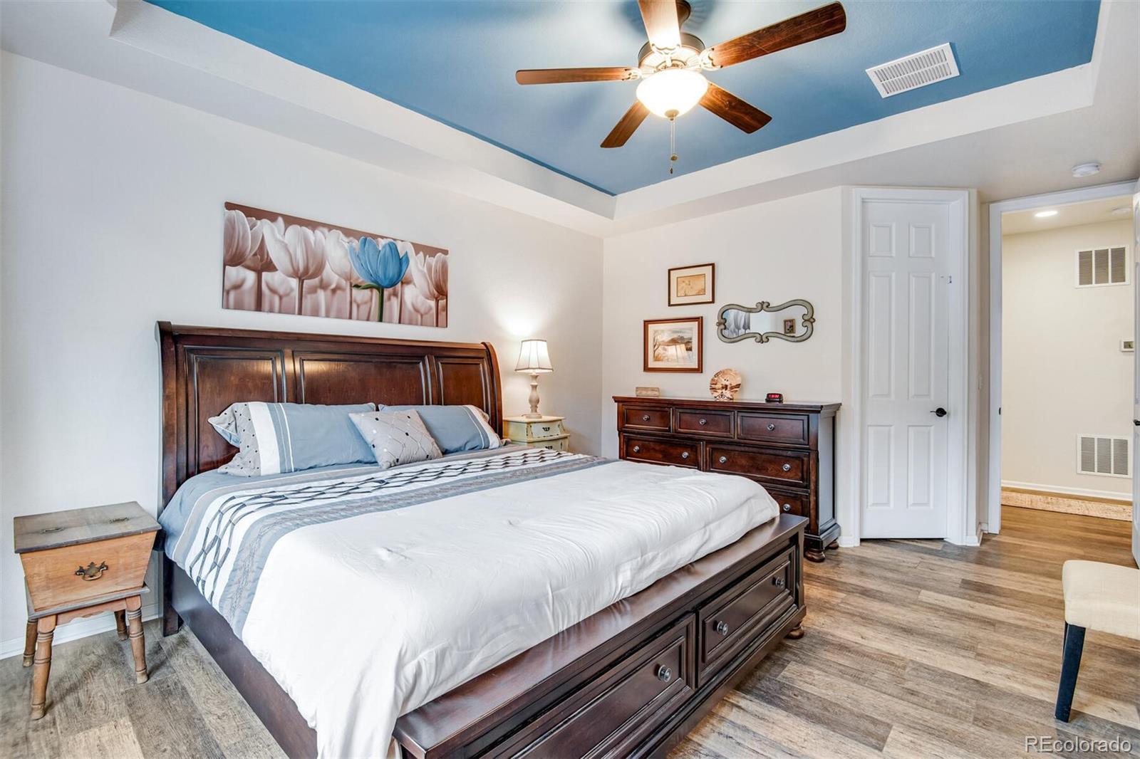 12646 Eagle River Road Firestone, CO 80504 - Photo 29 of 40 a bedroom with a bed and a chandelier