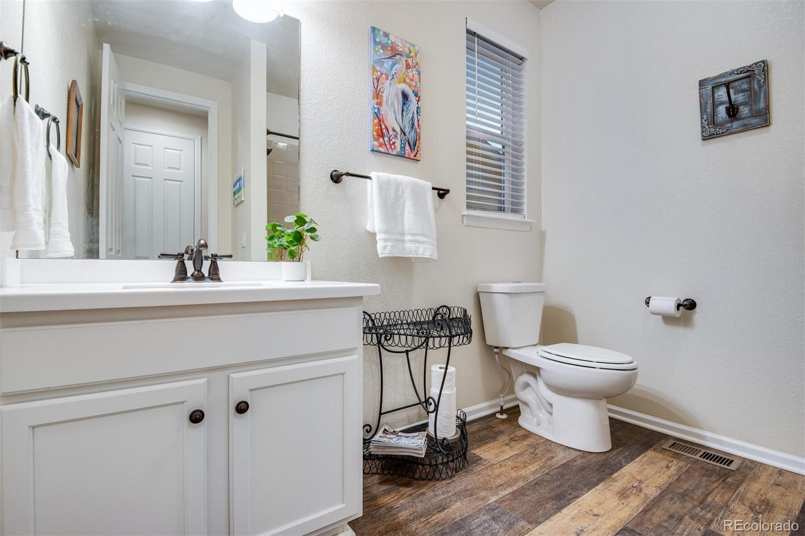 12646 Eagle River Road Firestone, CO 80504 - Photo 38 of 40 a bathroom with a toilet a sink and a mirror