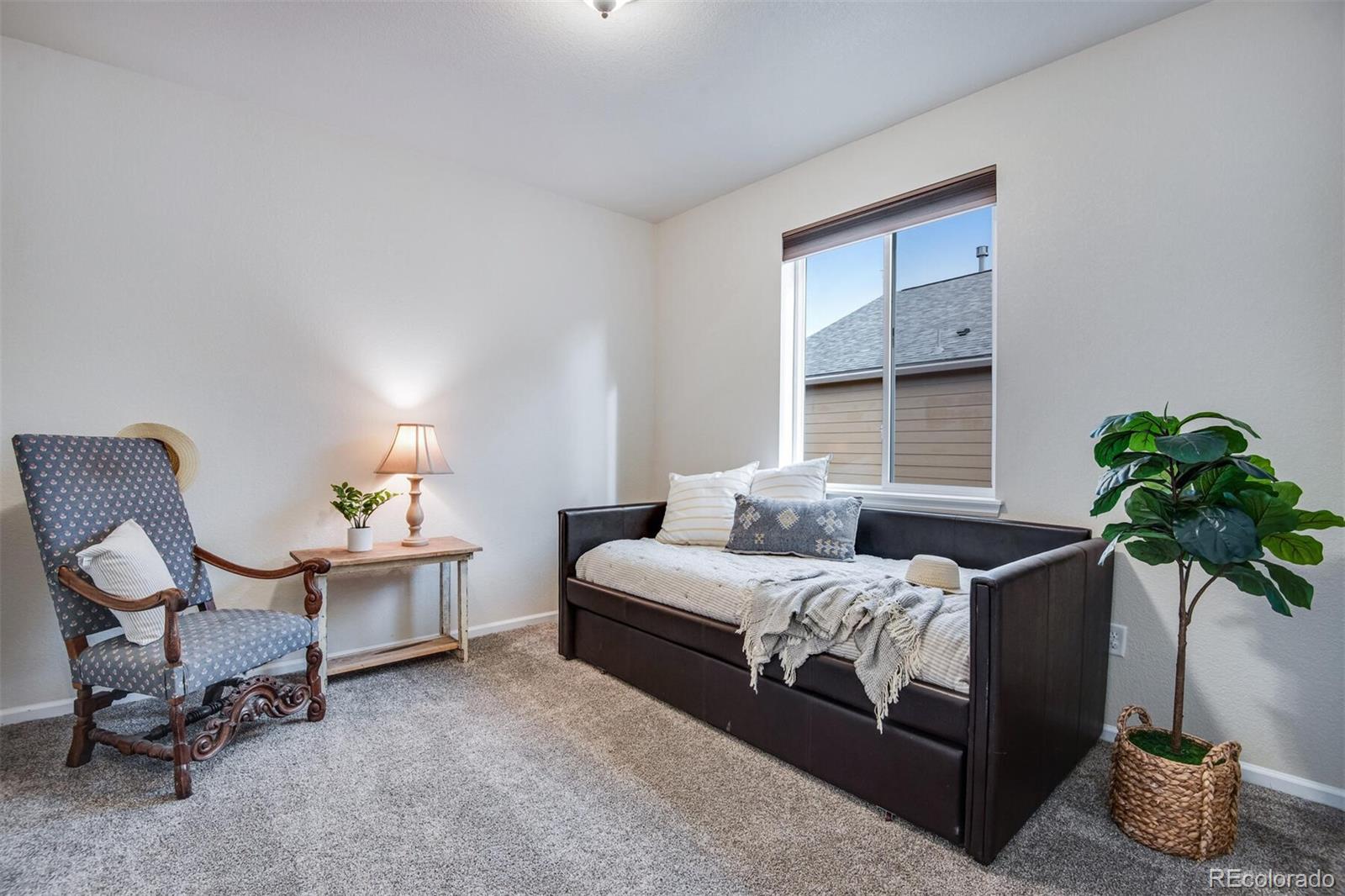12646 Eagle River Road Firestone, CO 80504 - Photo 39 of 40 a bedroom with bed and a potted plant