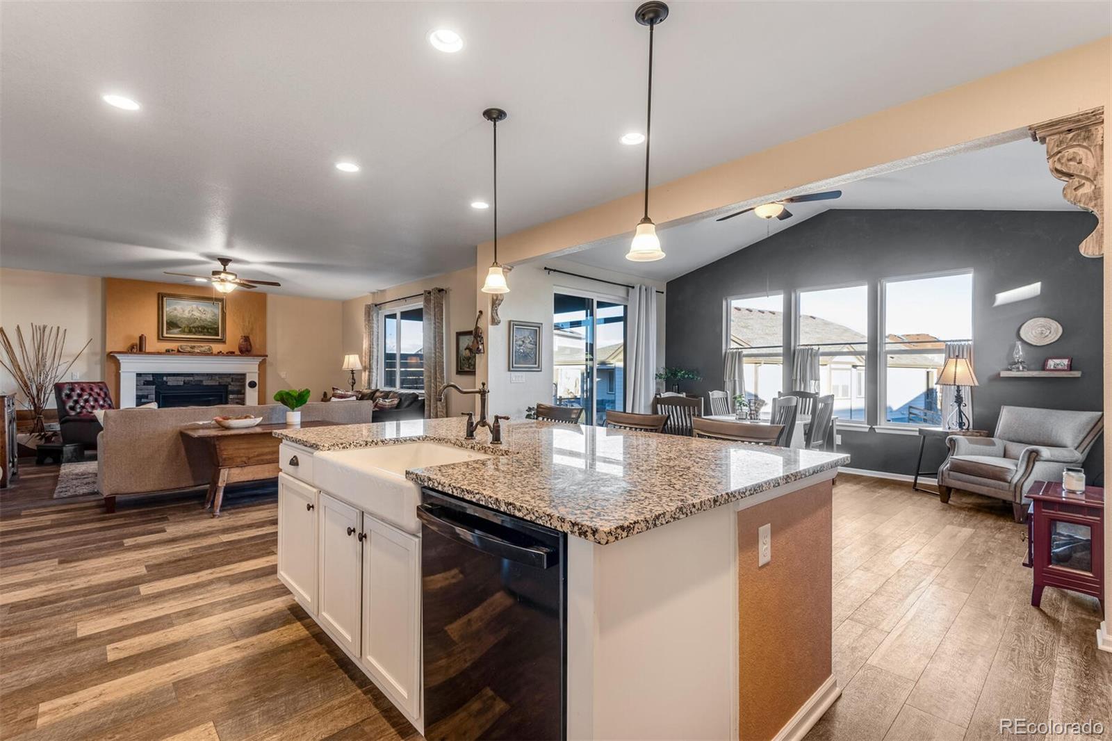 12646 Eagle River Road Firestone, CO 80504 - Photo 8 of 40 a kitchen with stainless steel appliances granite countertop a sink counter space and a large window