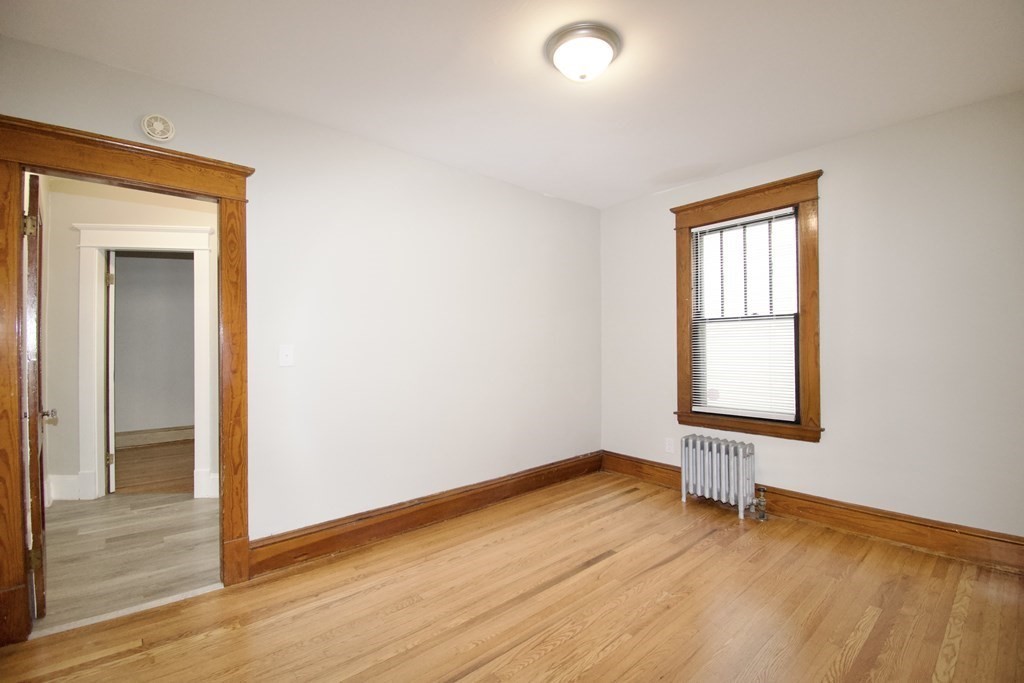 403-405 Main Street Springfield, MA 01151 - Photo 11 of 27 a view of an empty room with wooden floor and a window