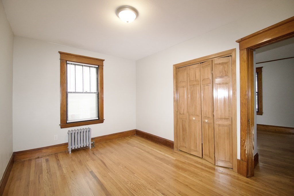 403-405 Main Street Springfield, MA 01151 - Photo 12 of 27 an empty room with wooden floor and windows