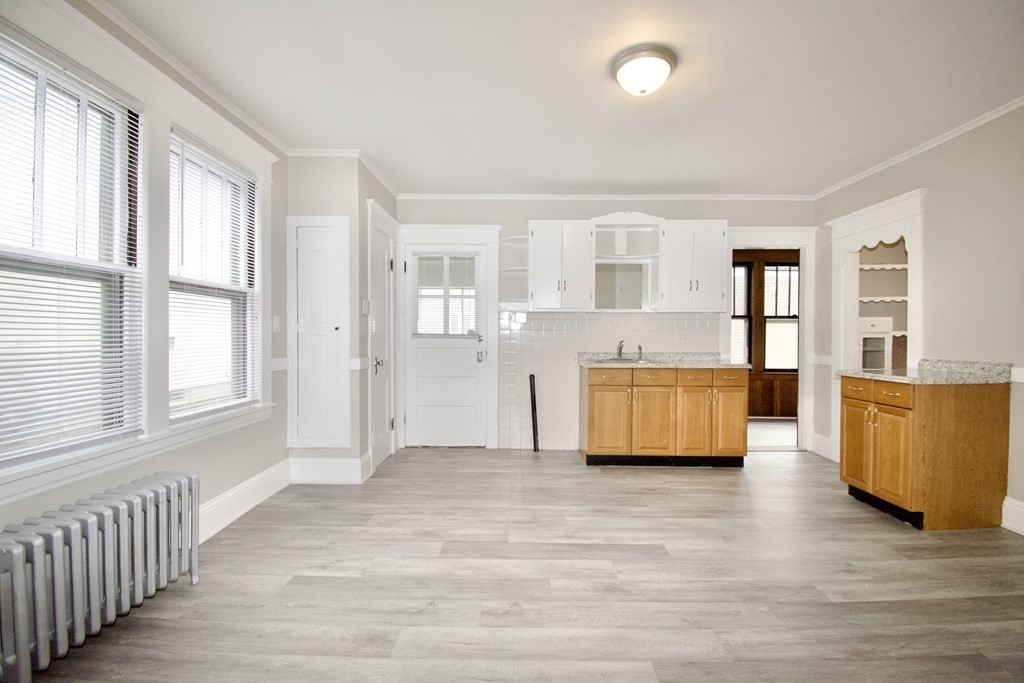 403-405 Main Street Springfield, MA 01151 - Photo 16 of 27 an empty room with wooden floor and windows