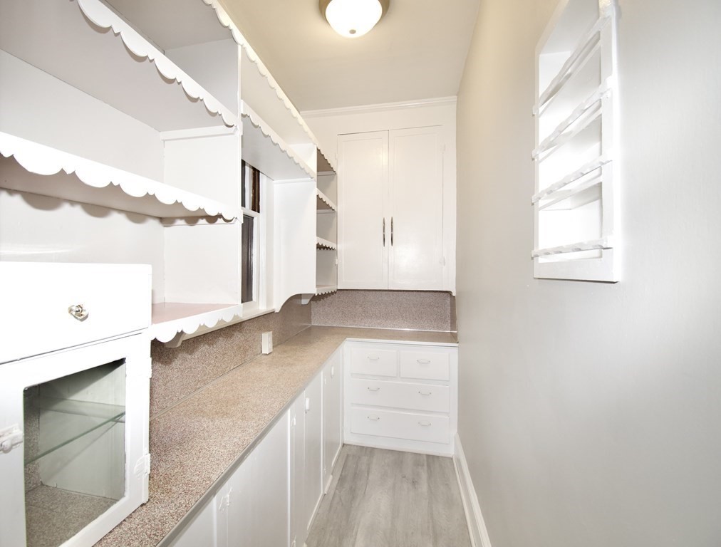 403-405 Main Street Springfield, MA 01151 - Photo 20 of 27 a view of a kitchen with a sink and dishwasher with wooden floor