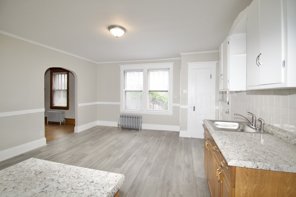 403-405 Main Street Springfield, MA 01151 - Photo 23 of 27 an empty room with wooden floor and a window