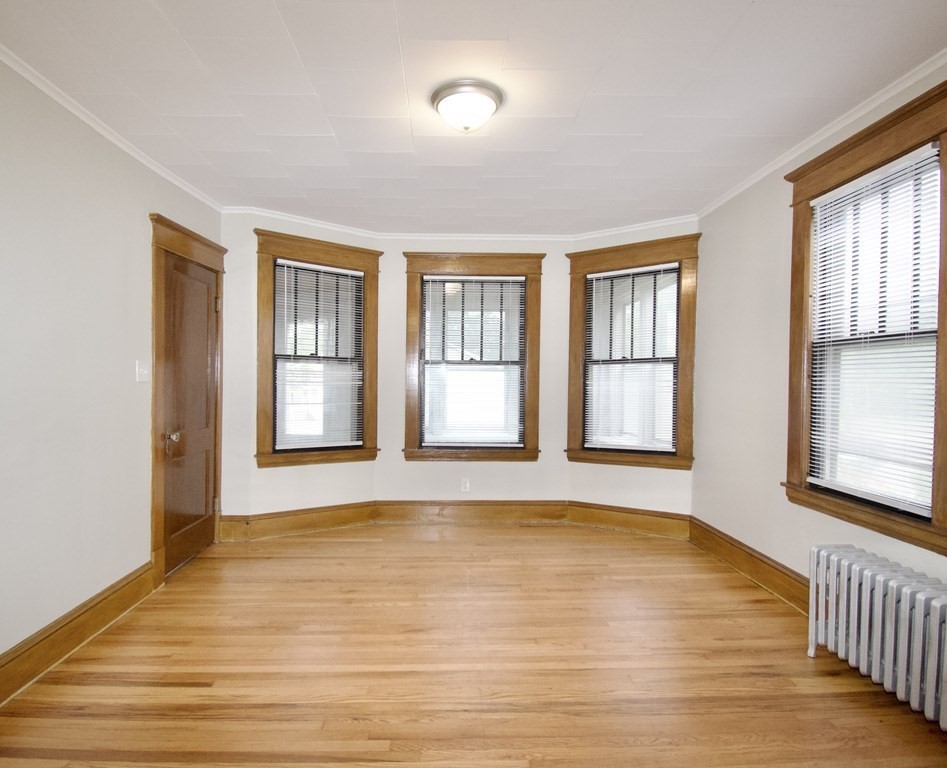 403-405 Main Street Springfield, MA 01151 - Photo 3 of 27 a view of an empty room with a window and wooden floor