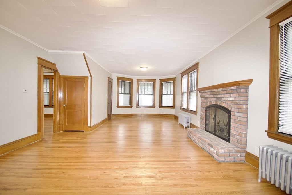 403-405 Main Street Springfield, MA 01151 - Photo 5 of 27 a view of empty room with wooden floor and fireplace