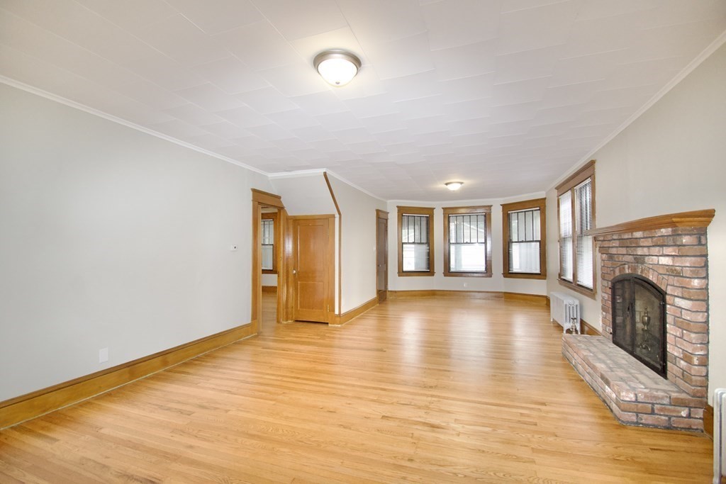403-405 Main Street Springfield, MA 01151 - Photo 6 of 27 a view of empty room with wooden floor and fireplace