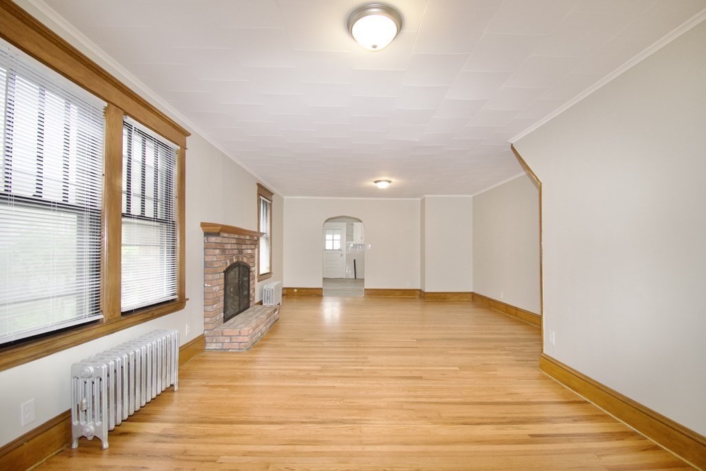 403-405 Main Street Springfield, MA 01151 - Photo 8 of 27 a view of an empty room with a fireplace and a window
