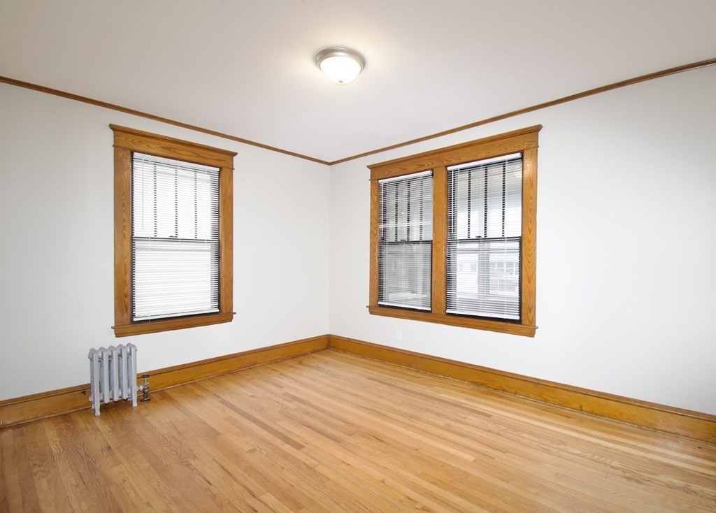 403-405 Main Street Springfield, MA 01151 - Photo 9 of 27 a view of an empty room with wooden floor and a window
