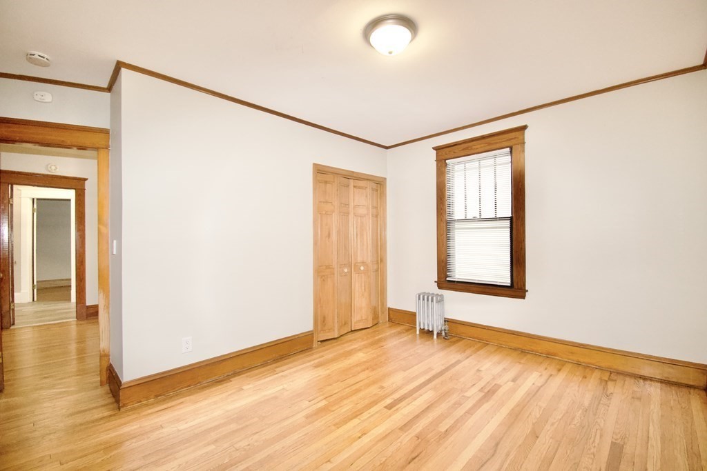 403-405 Main Street Springfield, MA 01151 - Photo 10 of 27 a view of an empty room with wooden floor and a window