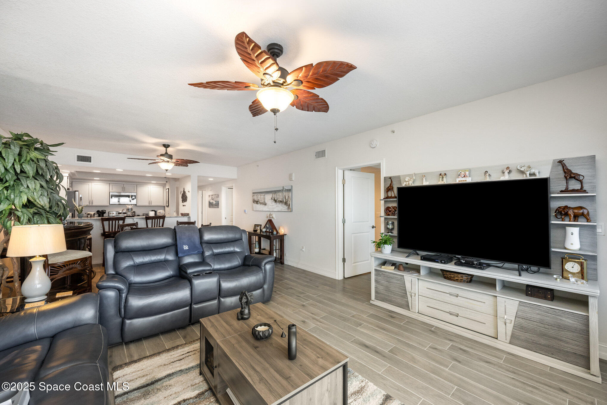 1825 Riverside Drive, Unit 202 Titusville, FL 32780 - Photo 11 of 31 a living room with furniture and a flat screen tv
