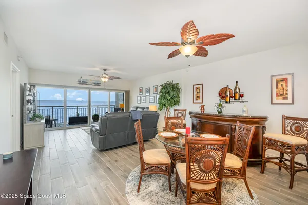 a living room with furniture and a kitchen view