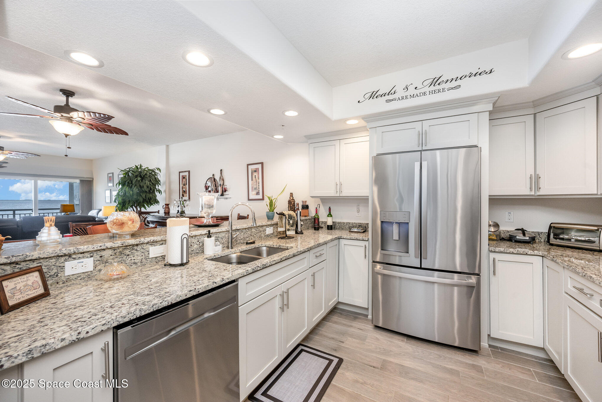 1825 Riverside Drive, Unit 202 Titusville, FL 32780 - Photo 16 of 31 a kitchen with granite countertop a refrigerator stove top oven and sink