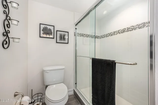 a bathroom with a toilet and a shower