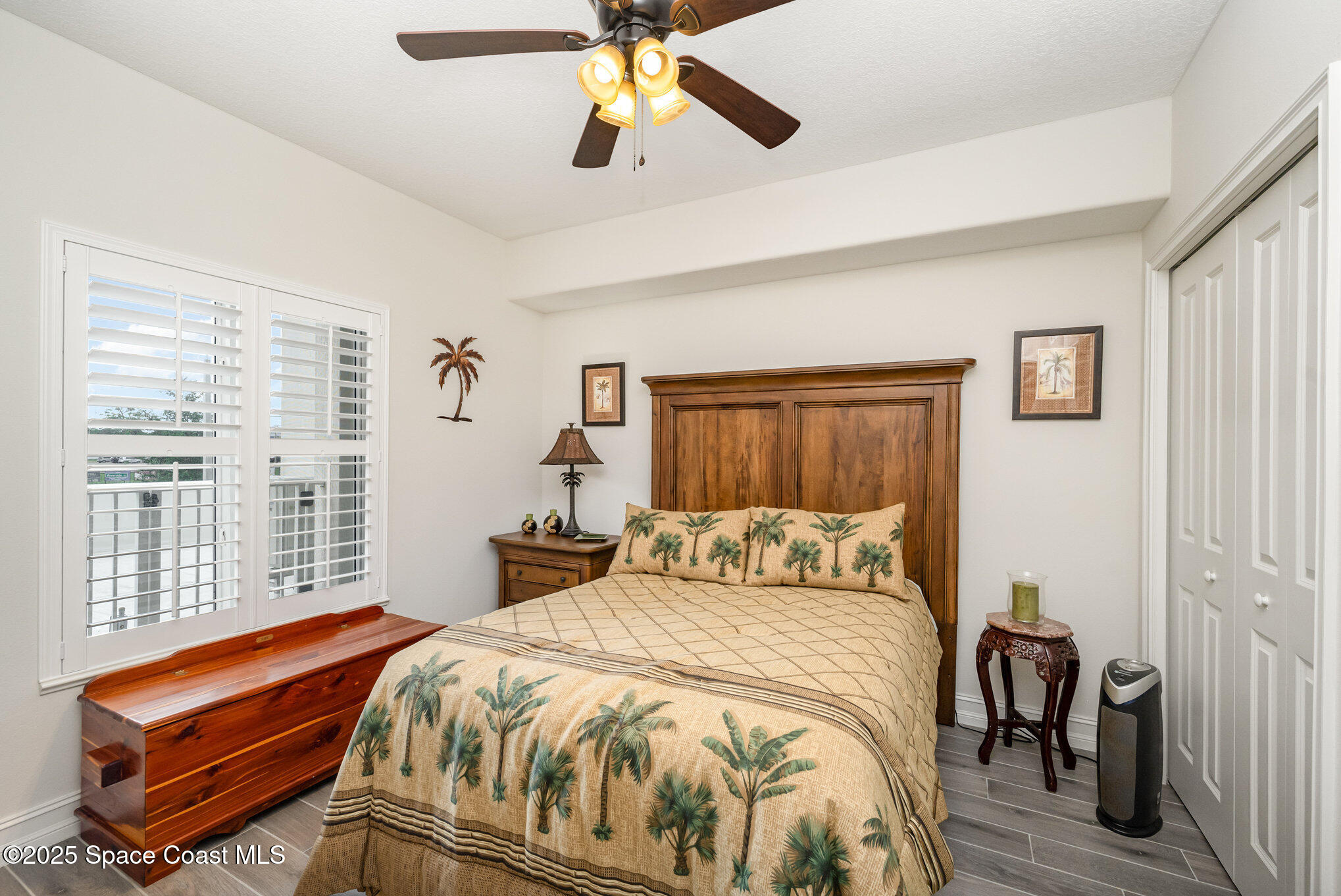 1825 Riverside Drive, Unit 202 Titusville, FL 32780 - Photo 23 of 31 a bedroom with a bed and a chandelier