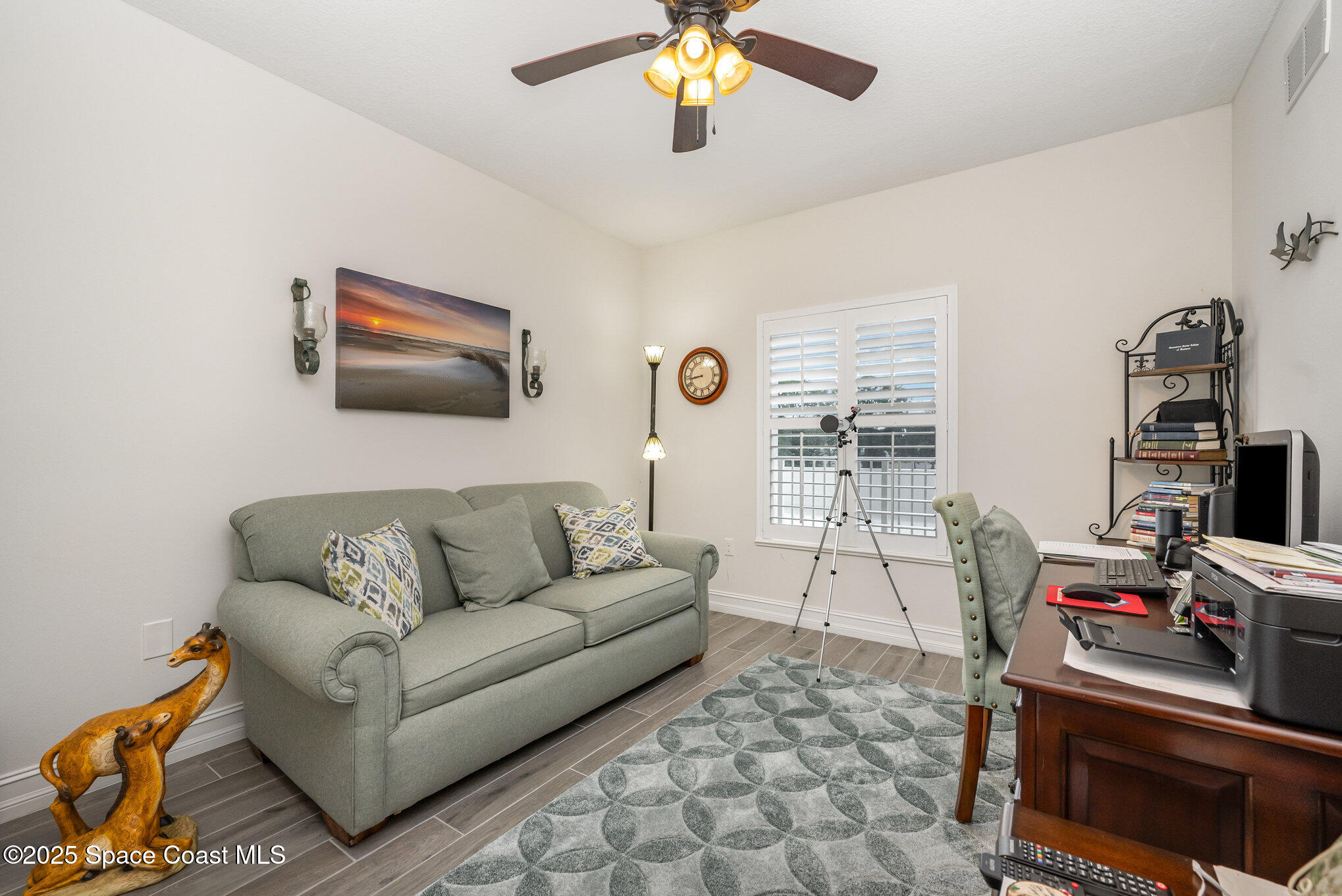 1825 Riverside Drive, Unit 202 Titusville, FL 32780 - Photo 26 of 31 a living room with furniture and a flat screen tv