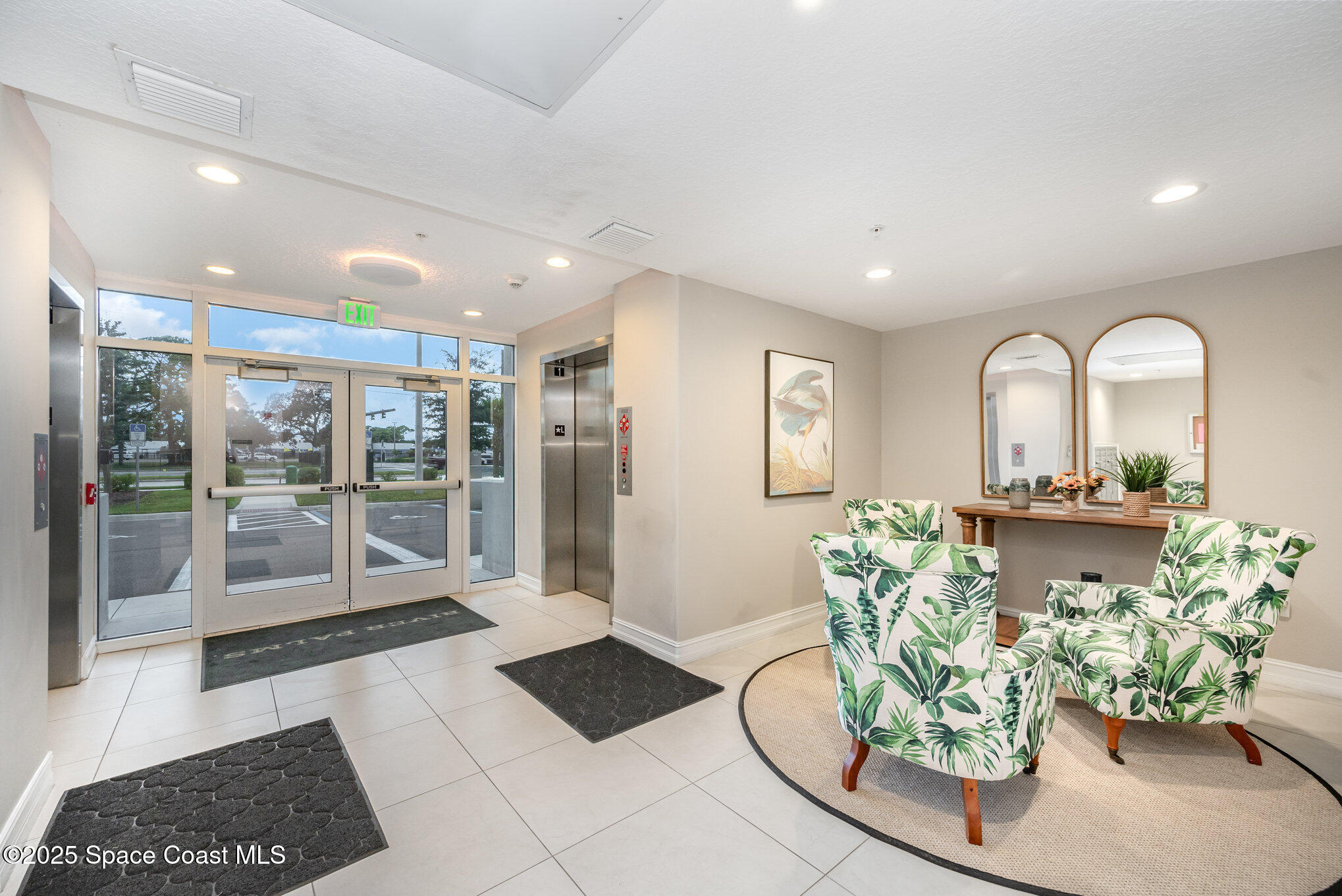 1825 Riverside Drive, Unit 202 Titusville, FL 32780 - Photo 7 of 31 a living room with furniture and a floor to ceiling window