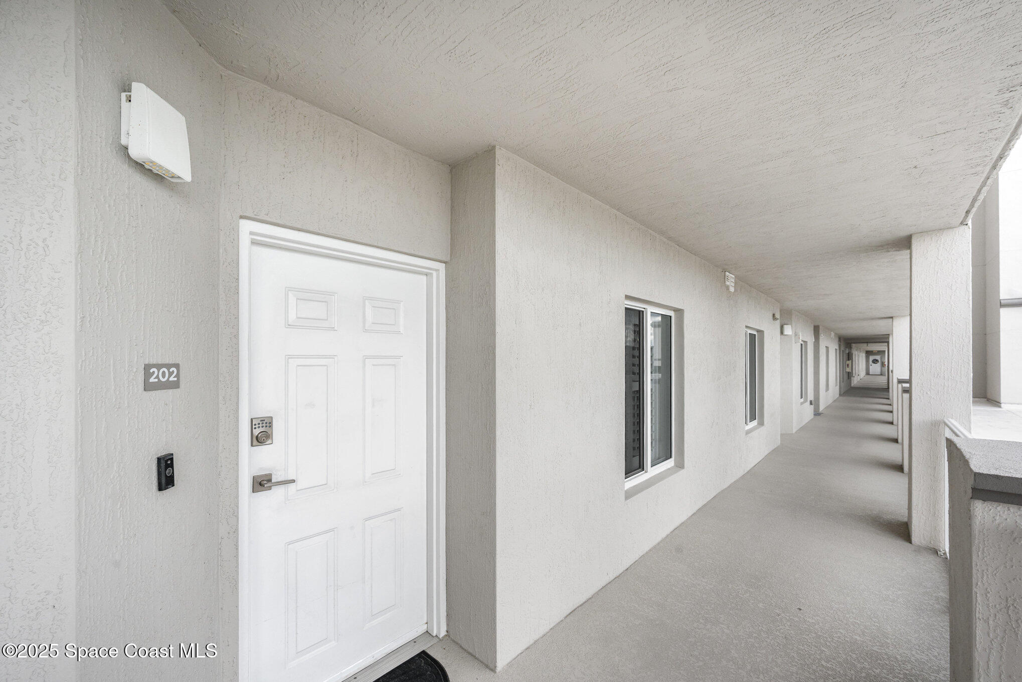 1825 Riverside Drive, Unit 202 Titusville, FL 32780 - Photo 8 of 31 a view of hallway with livingroom