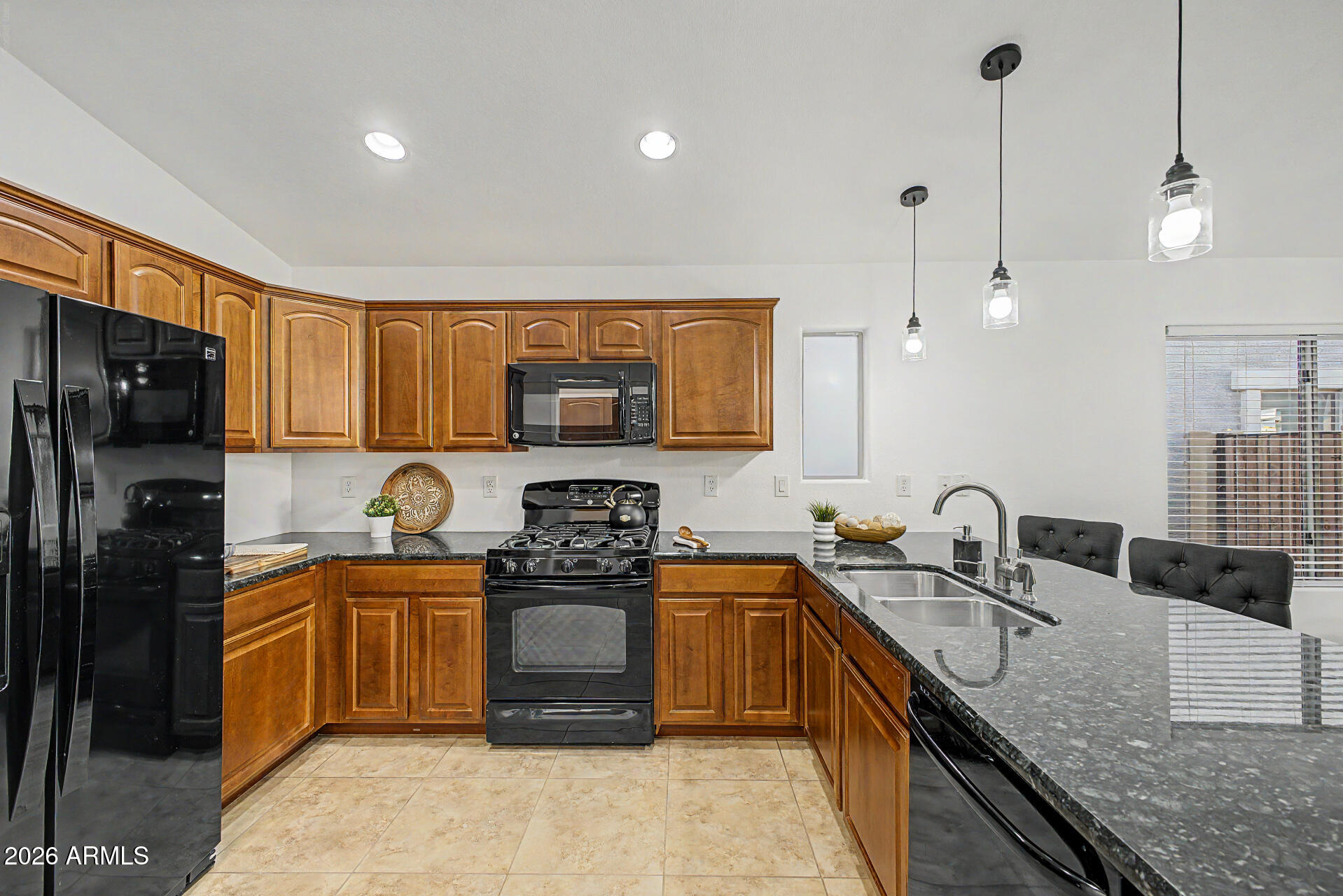 4168 East Sandy Way Gilbert, AZ 85297 - Photo 10 of 47 a kitchen with stainless steel appliances granite countertop a sink stove and refrigerator