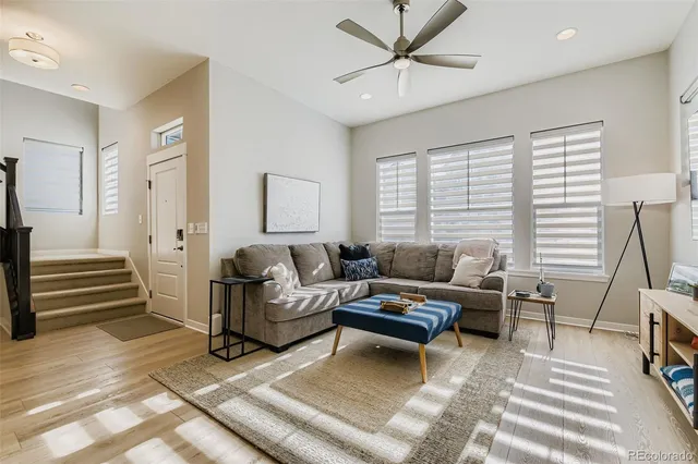a living room with furniture and a wooden floor