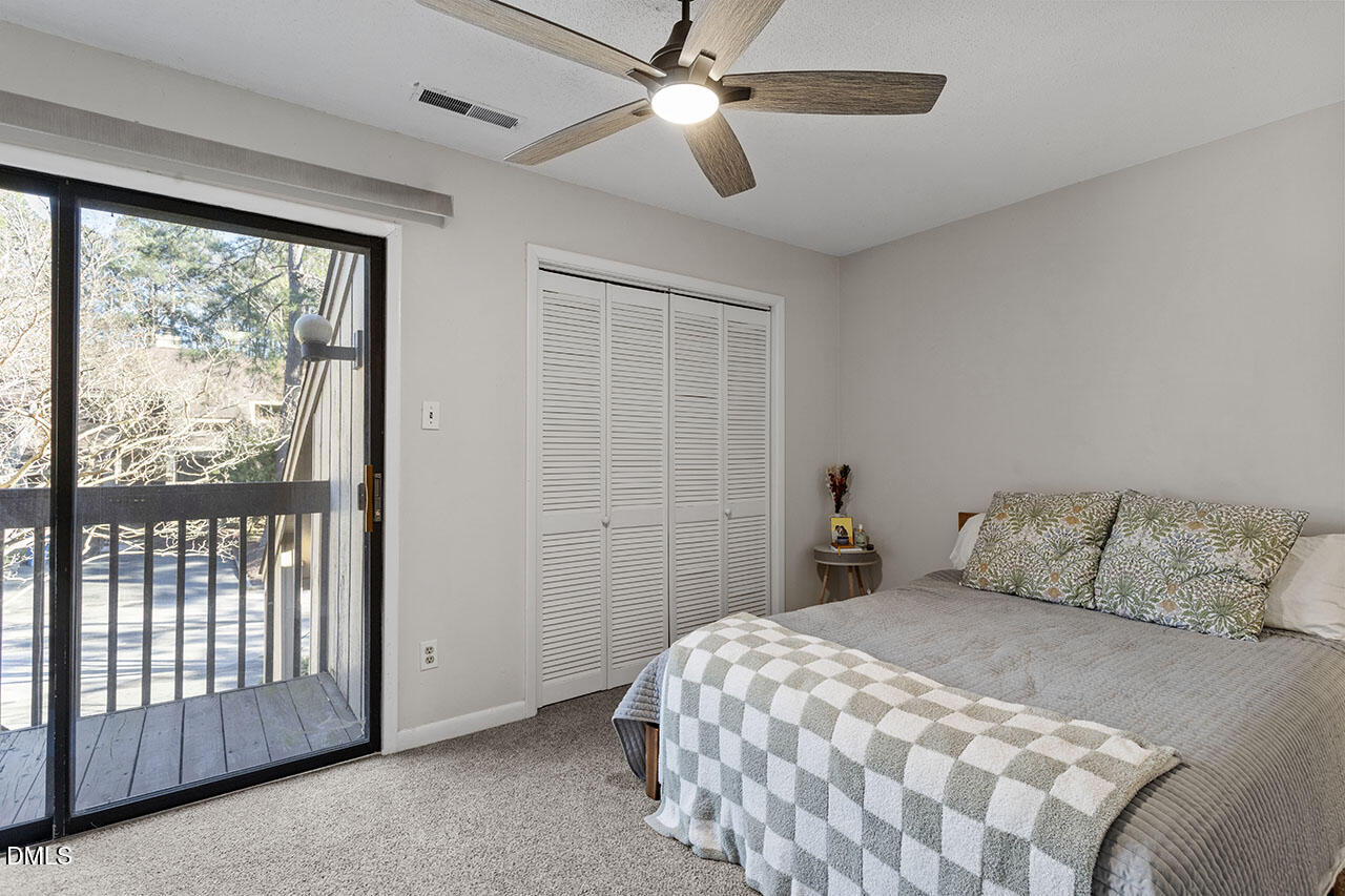 4100 Five Oaks Drive, Unit 37 Durham, NC 27707 - Photo 13 of 18 a bedroom with a large bed and a chandelier