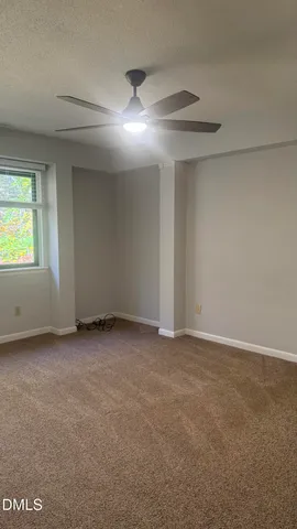 an empty room with a empty space and windows