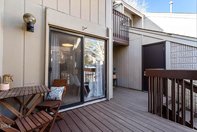 a view of a balcony with furniture and wooden floor