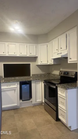 a kitchen with stainless steel appliances granite countertop a stove top oven and sink