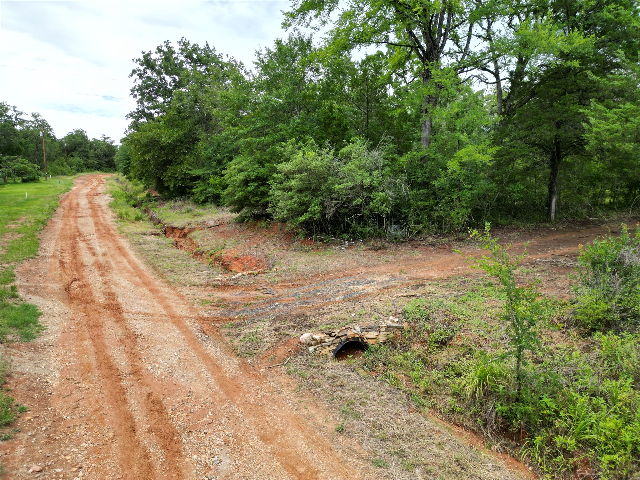 891 Cedar Creek Road Caldwell, TX 77836 - Photo 6 of 18 a view of a dirt road with trees in the background