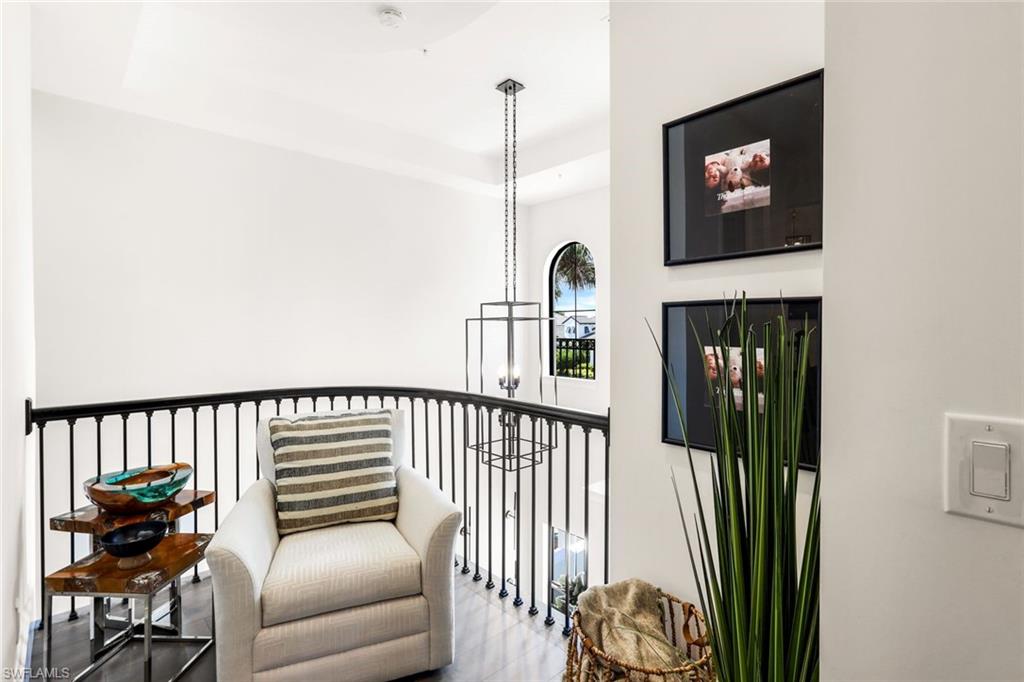 16366 Corsica Way, Unit 201 Naples, FL 34110 - Photo 8 of 39 a view of a hallway with couches and a rug