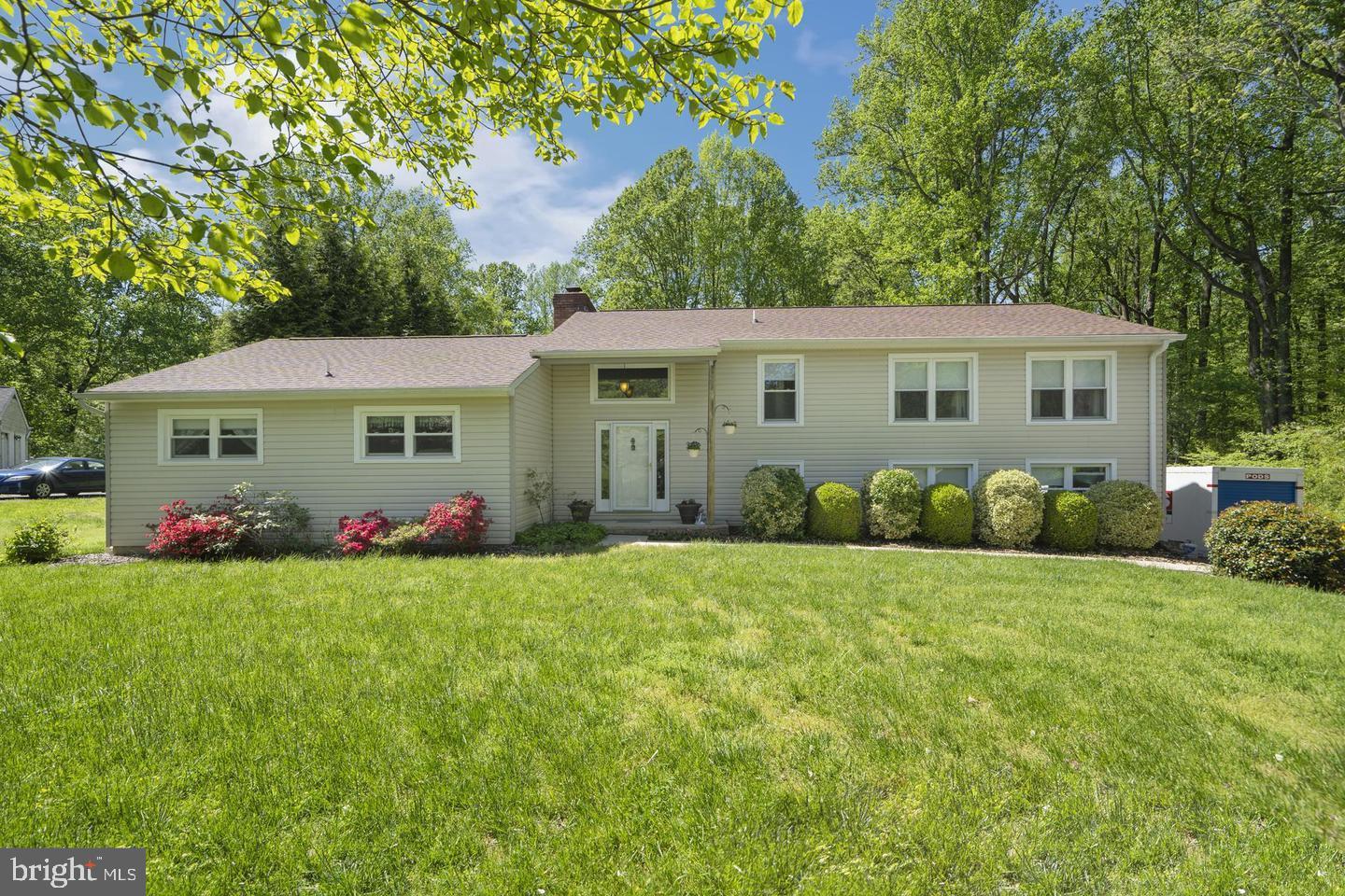 a view of a house with a big yard and potted plants