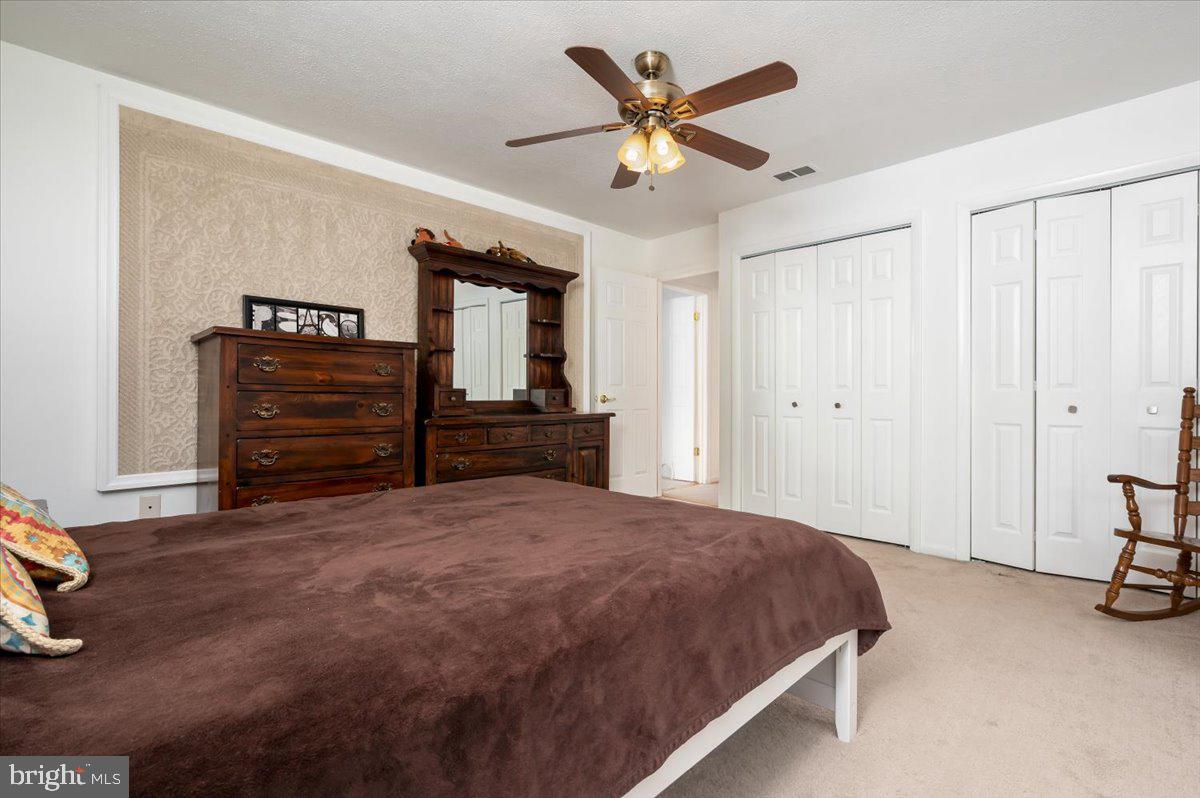 6343 Meadowland Drive Dunkirk, MD 20754 - Photo 17 of 31 a spacious bedroom with a bed and a chandelier
