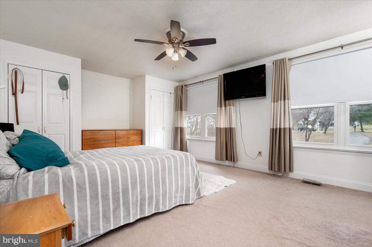 6343 Meadowland Drive Dunkirk, MD 20754 - Photo 18 of 31 a bedroom with a bed a flat screen tv and a couch