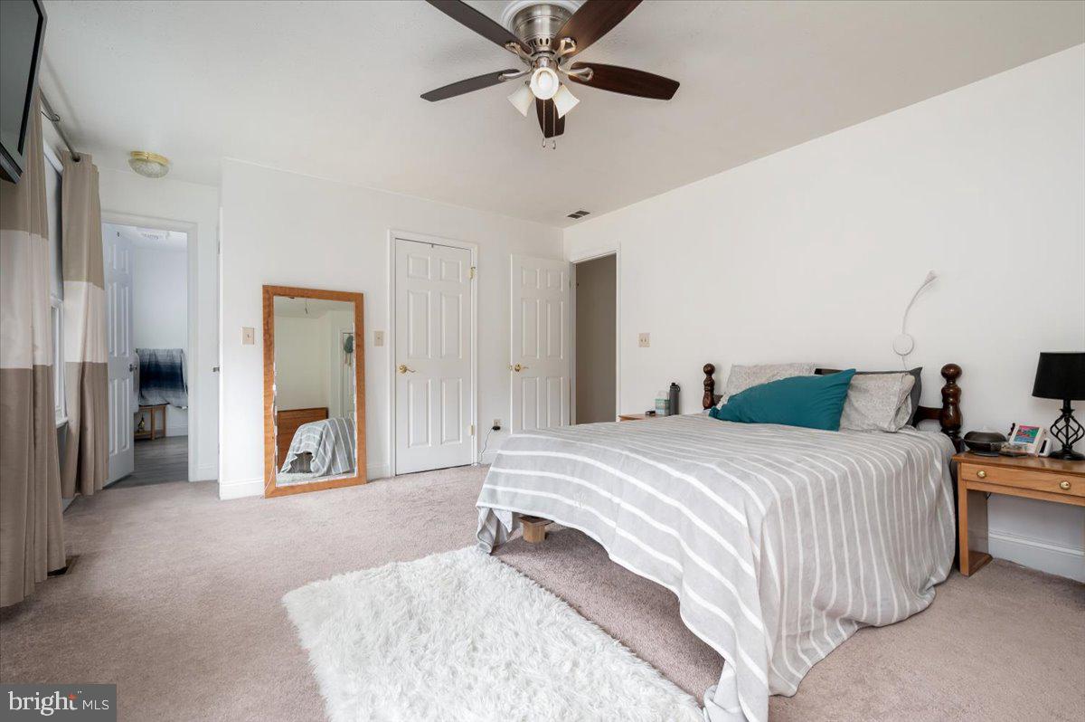 6343 Meadowland Drive Dunkirk, MD 20754 - Photo 20 of 31 a spacious bedroom with a bed and a chandelier