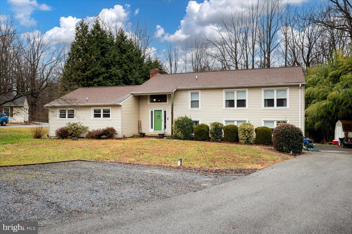 6343 Meadowland Drive Dunkirk, MD 20754 - Photo 2 of 31 a front view of a house with a yard and garage