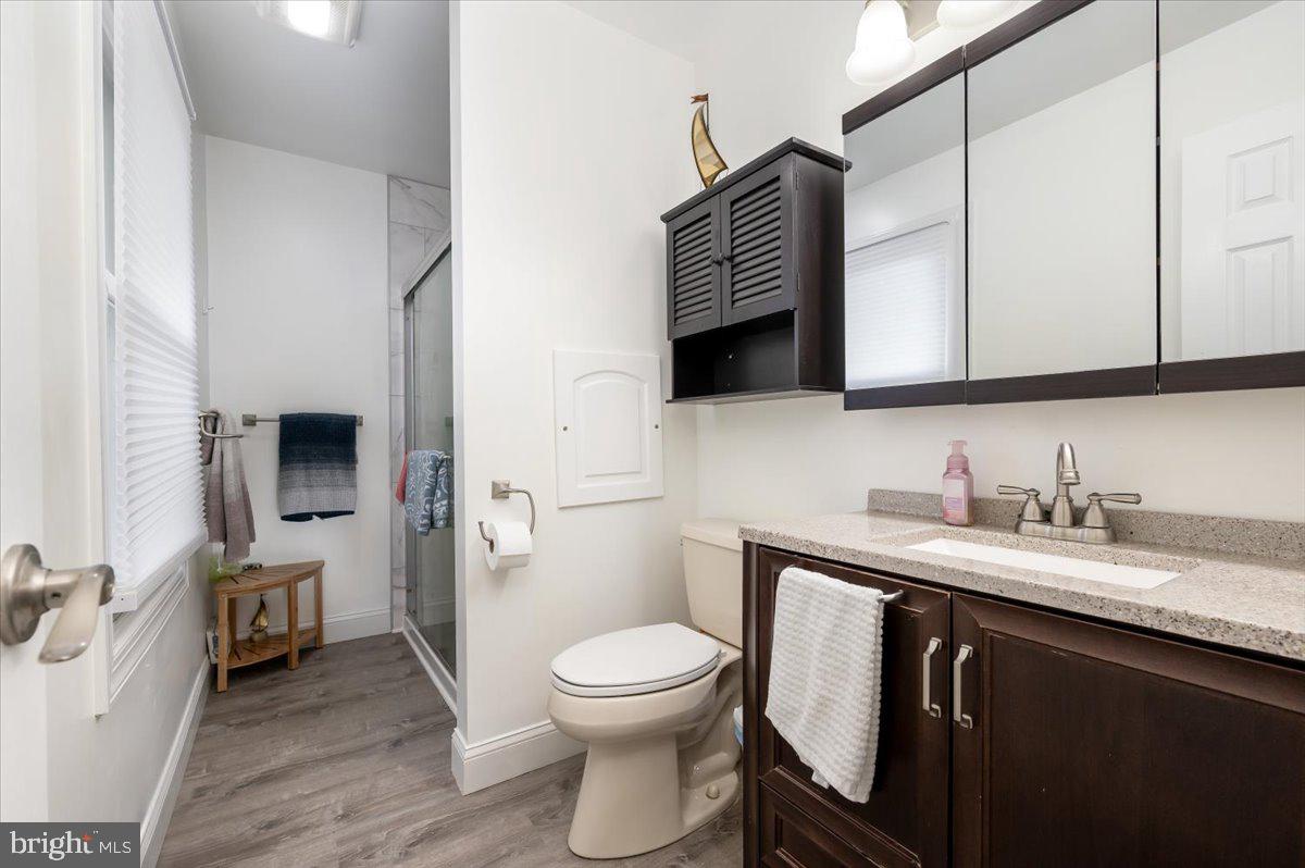 6343 Meadowland Drive Dunkirk, MD 20754 - Photo 21 of 31 a bathroom with a granite countertop toilet sink and mirror