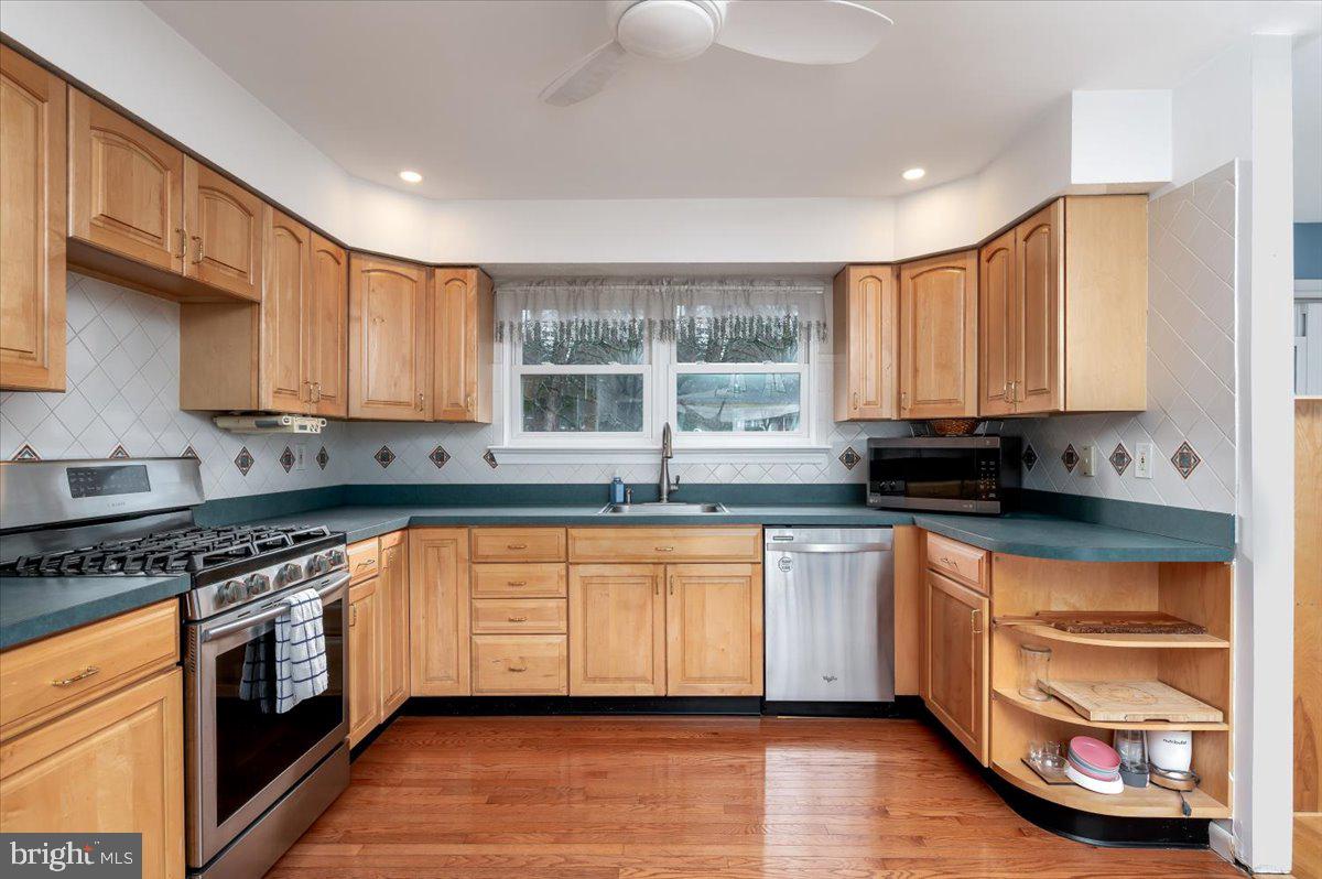 6343 Meadowland Drive Dunkirk, MD 20754 - Photo 8 of 31 a kitchen with stainless steel appliances granite countertop a stove a sink and a granite counter tops with wooden floors